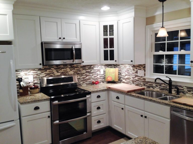 remodeled kitchen with accent lighting, decorative wall splash, wood finish kitchen flooring
