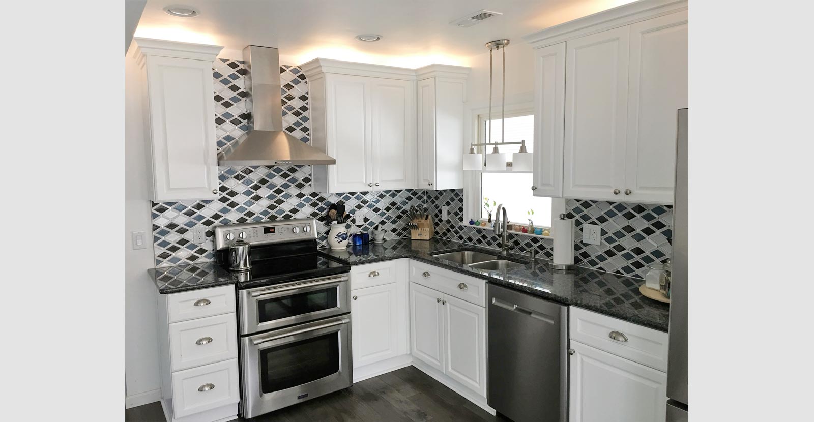 kitchen remodeling featuring stove ventilation system and decorative wall splash